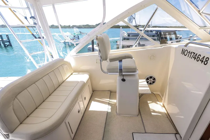 Patriot Yacht Photos Pics 2005 Carolina Classic 32 boat interior with seating and helm, overlooking serene blue waters.