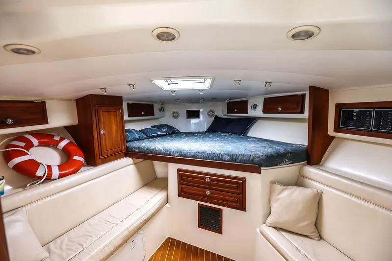Patriot Yacht Photos Pics 2005 Carolina Classic 32 cabin interior with bed, seating, and wooden cabinetry.