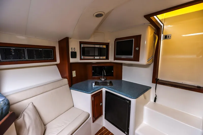 Patriot Yacht Photos Pics 2005 Carolina Classic 32 cabin interior with kitchenette, seating, and modern amenities.