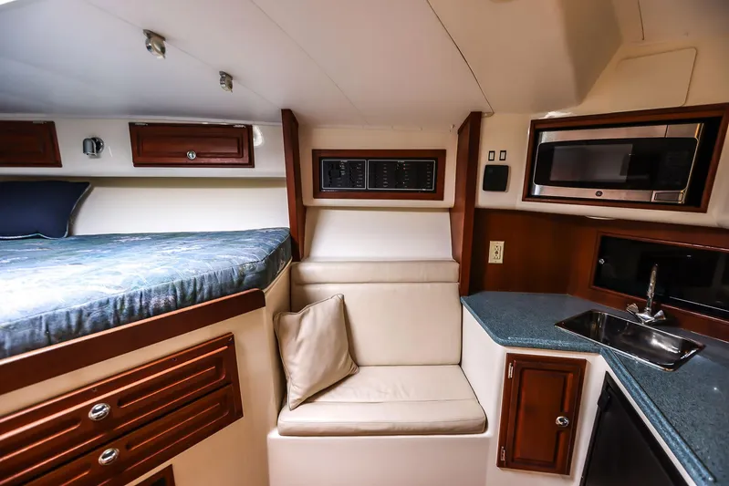 Patriot Yacht Photos Pics 2005 Carolina Classic 32 cabin interior with bed, seating, kitchenette, and storage.
