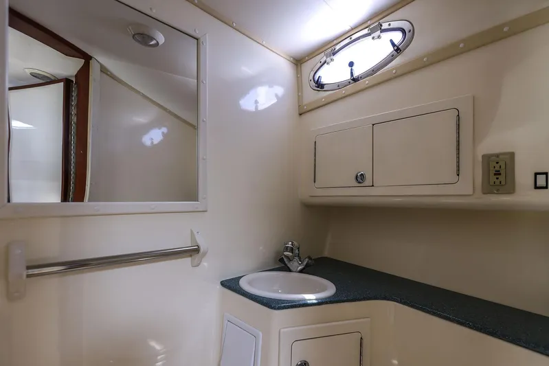 Patriot Yacht Photos Pics 2005 Carolina Classic 32 boat bathroom with sink, mirror, and storage cabinets.