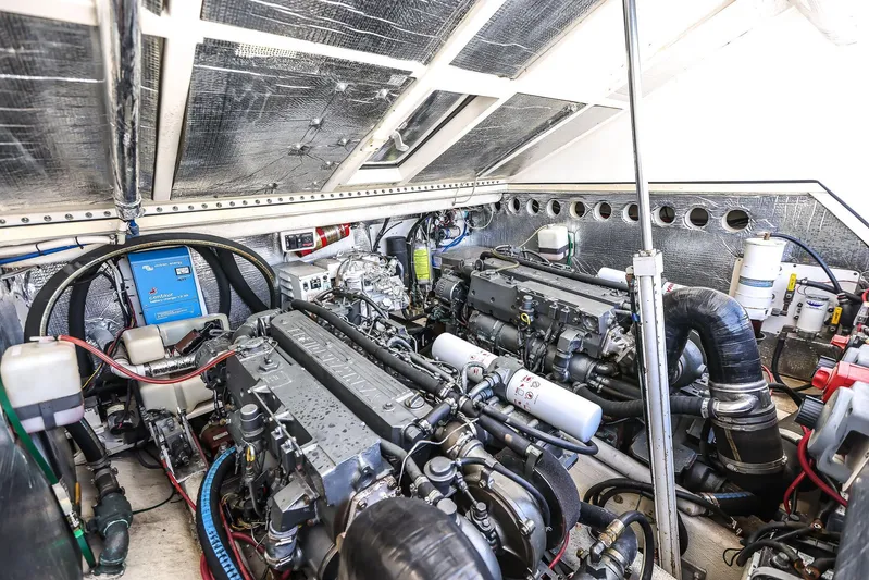 Patriot Yacht Photos Pics Engine room of a 2005 Carolina Classic 32 boat, showcasing dual engines and mechanical components.