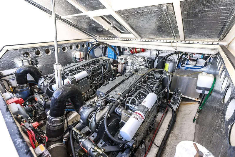 Patriot Yacht Photos Pics Engine room of a 2005 Carolina Classic 32 boat, showcasing dual engines and mechanical components.