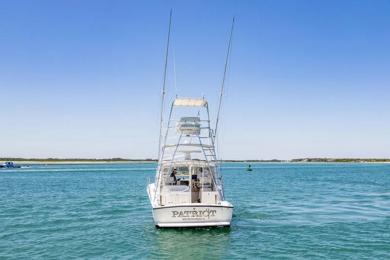 Patriot Yacht Photos Pics 2005 Carolina Classic 32 boat on clear blue water, rear view.
