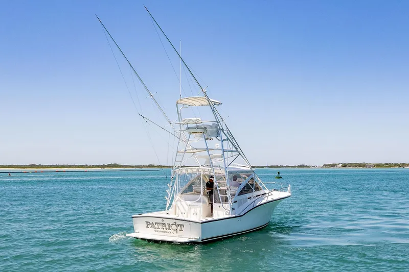 Patriot Yacht Photos Pics 2005 Carolina Classic 32 boat cruising on clear blue water under a sunny sky.
