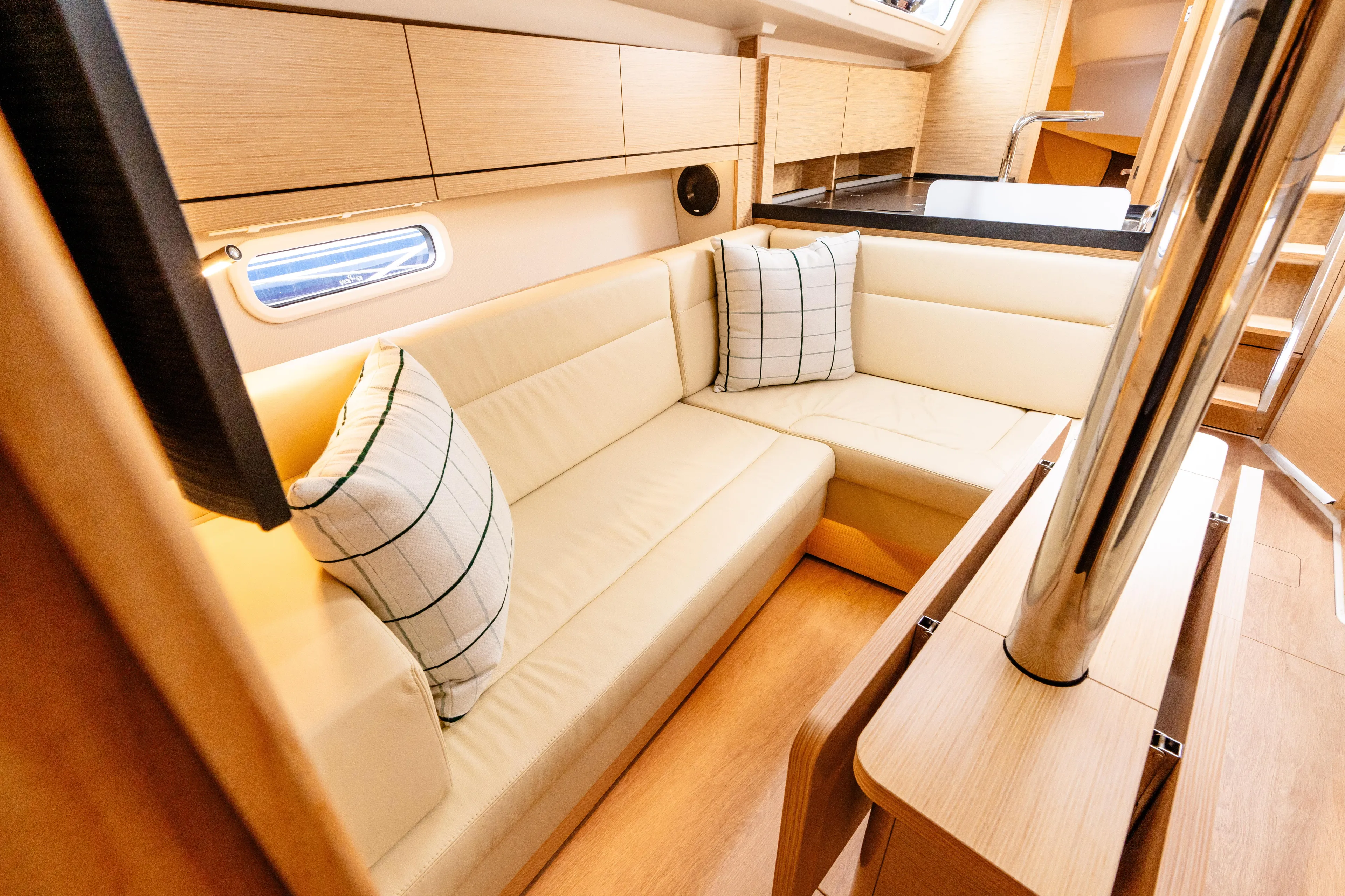 The Siren's Song Yacht Photos Pics 2023 Hanse 348 yacht interior with beige seating, wooden finish, and modern design.