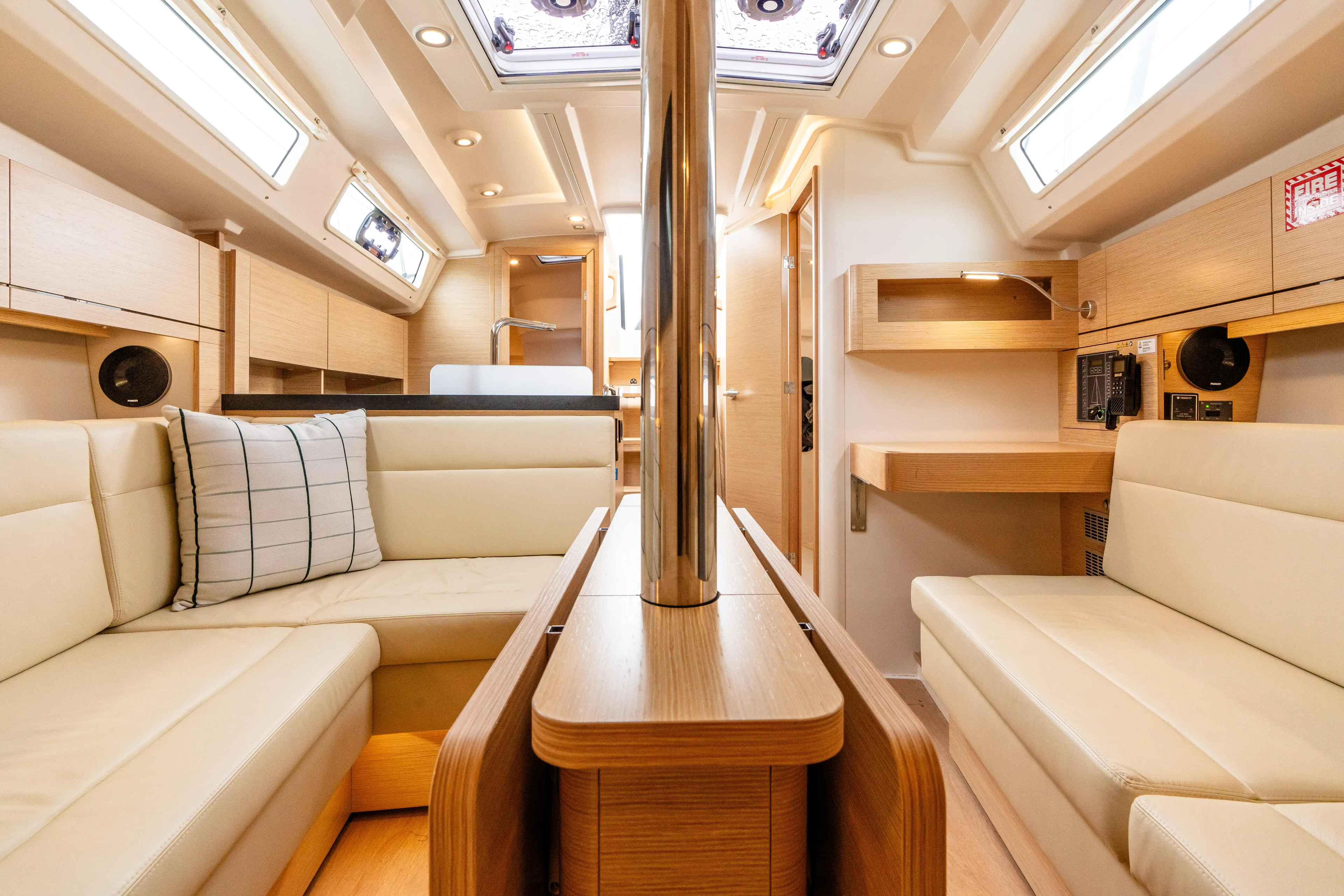 The Siren's Song Yacht Photos Pics Luxurious interior of 2023 Hanse 348 yacht with modern furnishings and ample natural light.