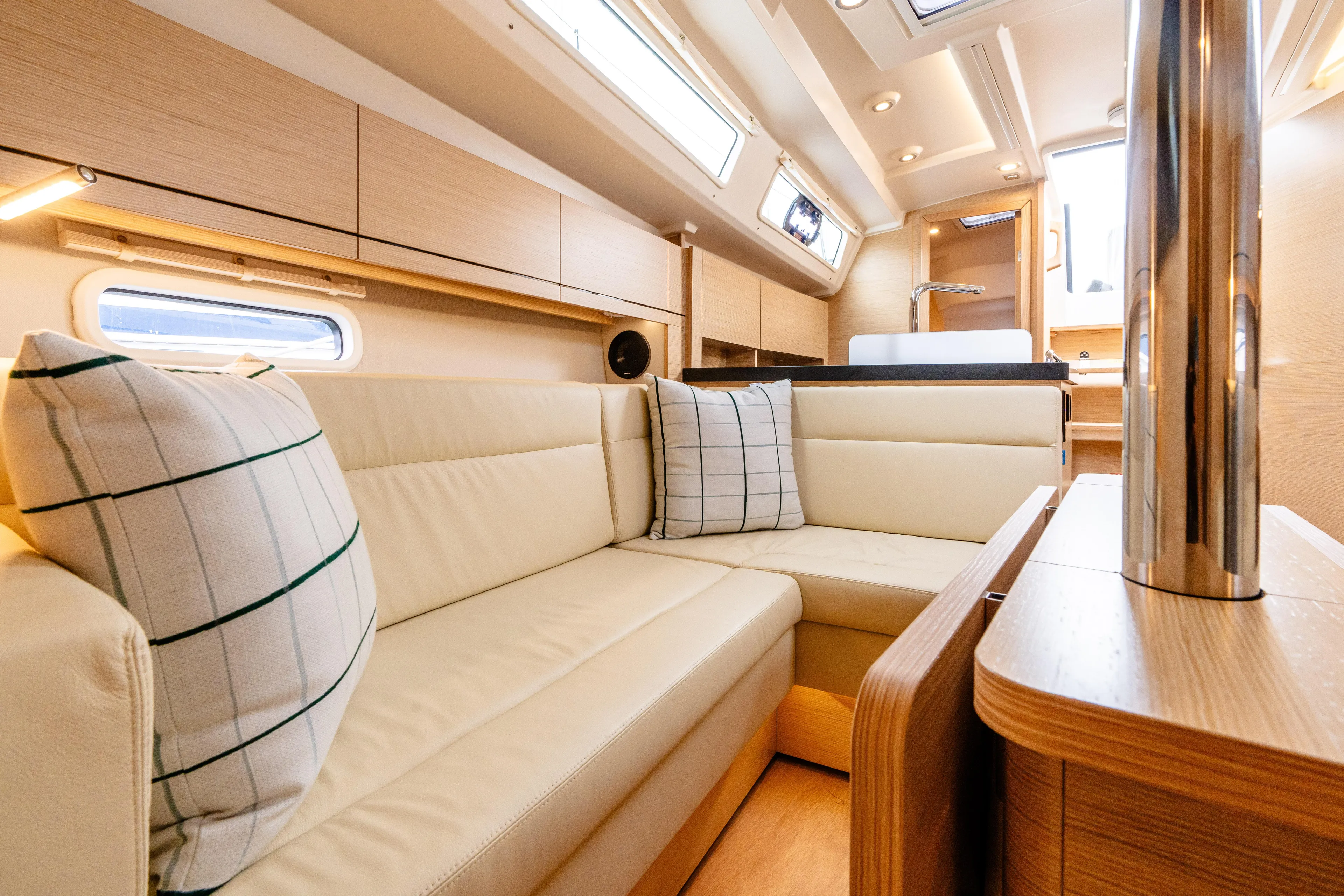 The Siren's Song Yacht Photos Pics Luxurious interior of 2023 Hanse 348 yacht with beige seating and modern design.