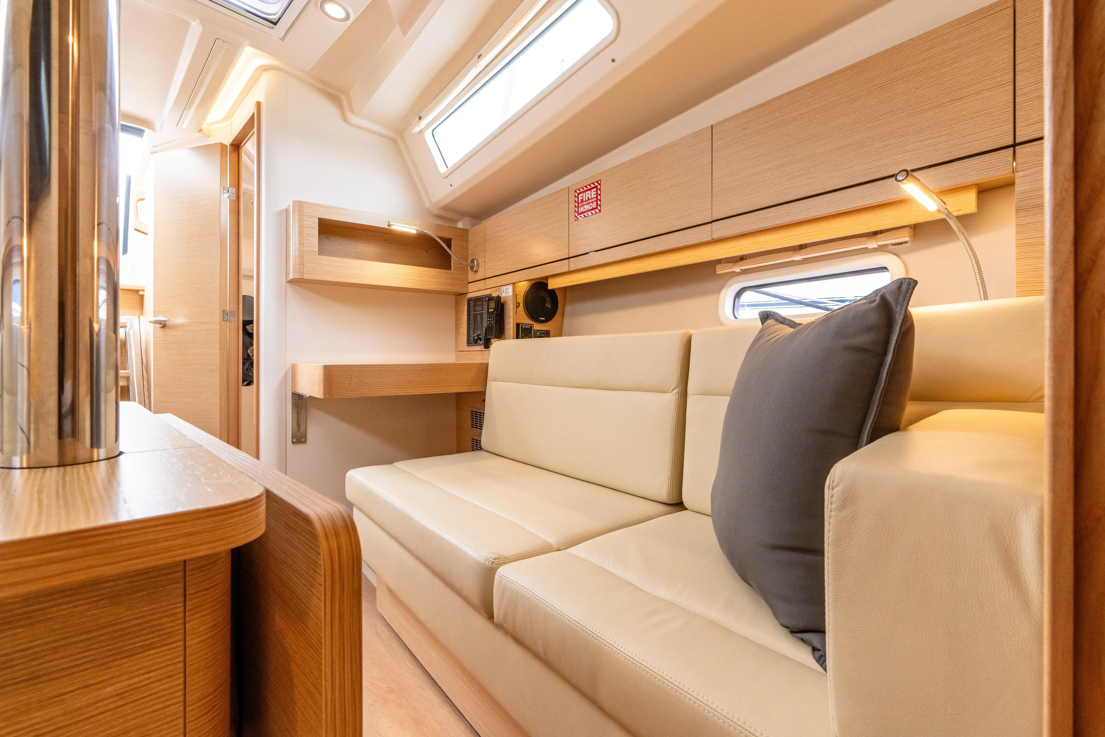 The Siren's Song Yacht Photos Pics Luxurious interior of 2023 Hanse 348 yacht with beige seating and modern design.