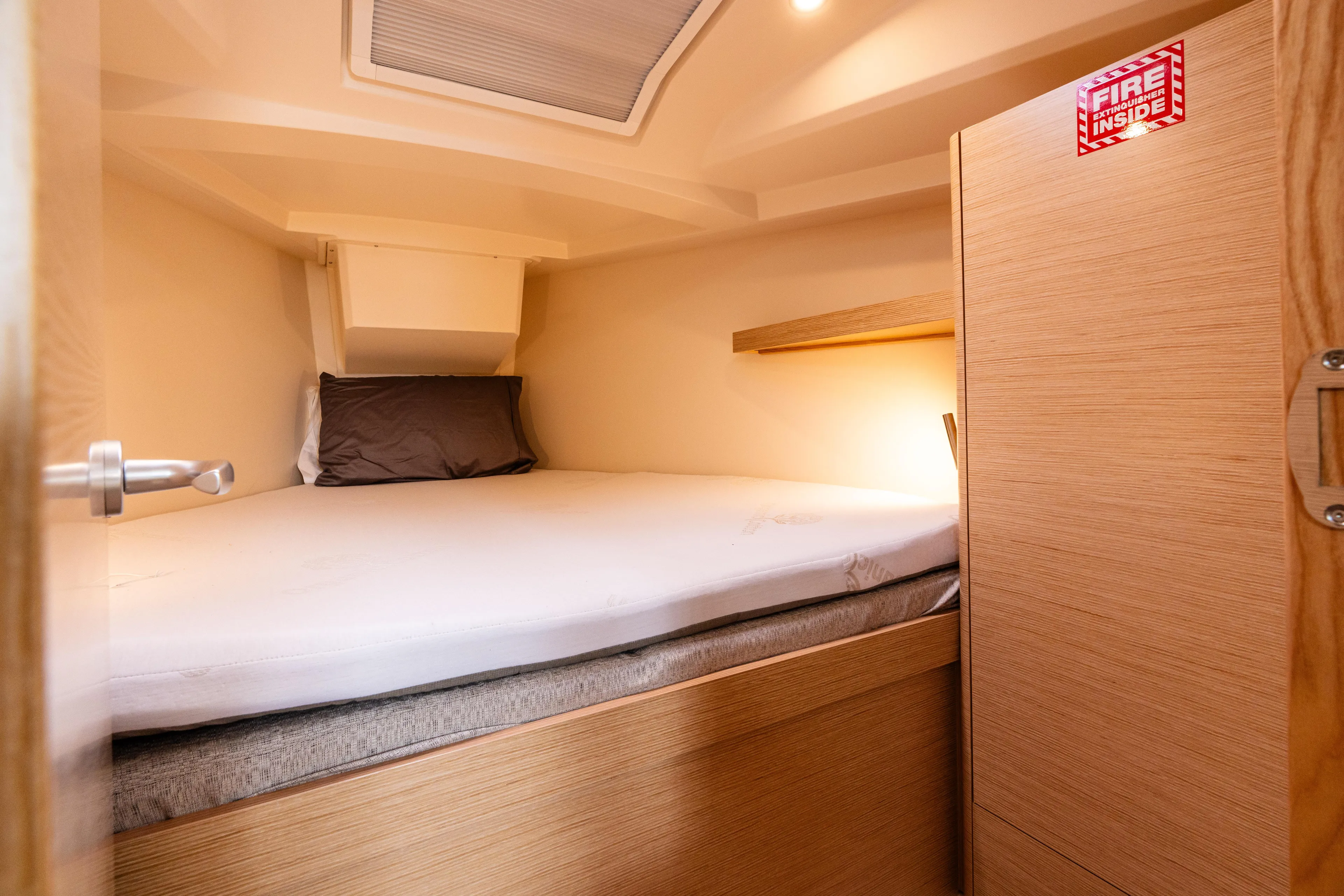 The Siren's Song Yacht Photos Pics Cozy cabin interior of 2023 Hanse 348 yacht with bed and wooden furnishings.