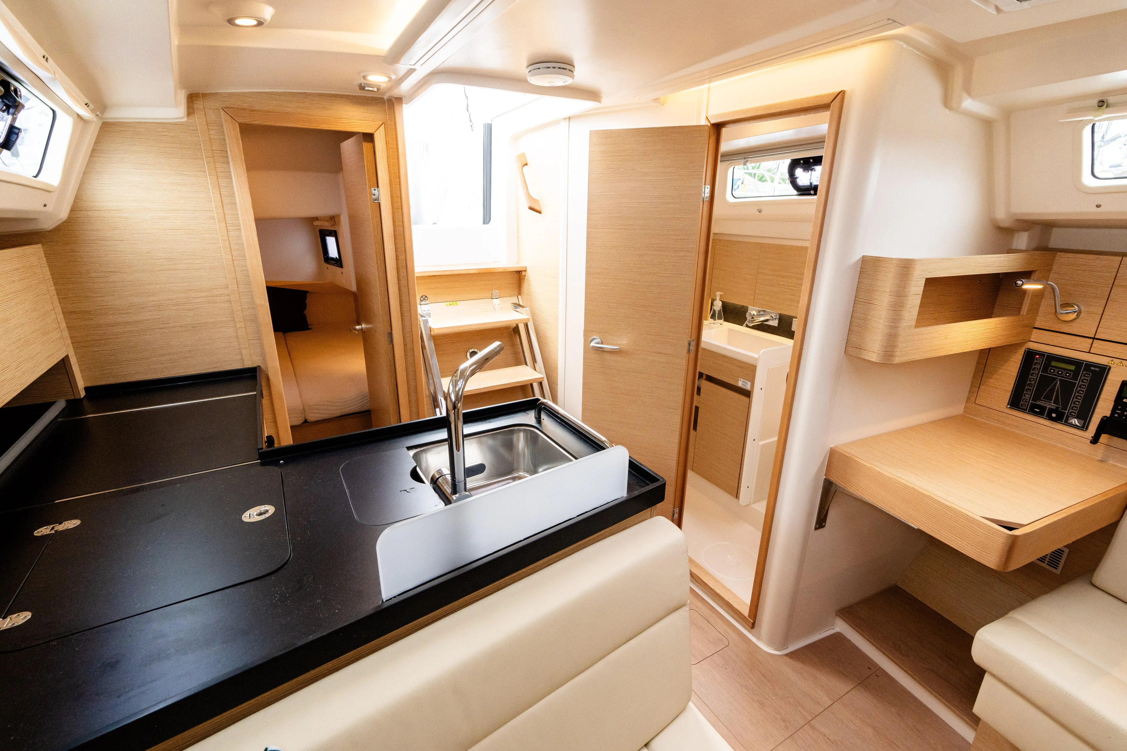 The Siren's Song Yacht Photos Pics 2023 Hanse 348 yacht interior with modern kitchen and cozy seating area.