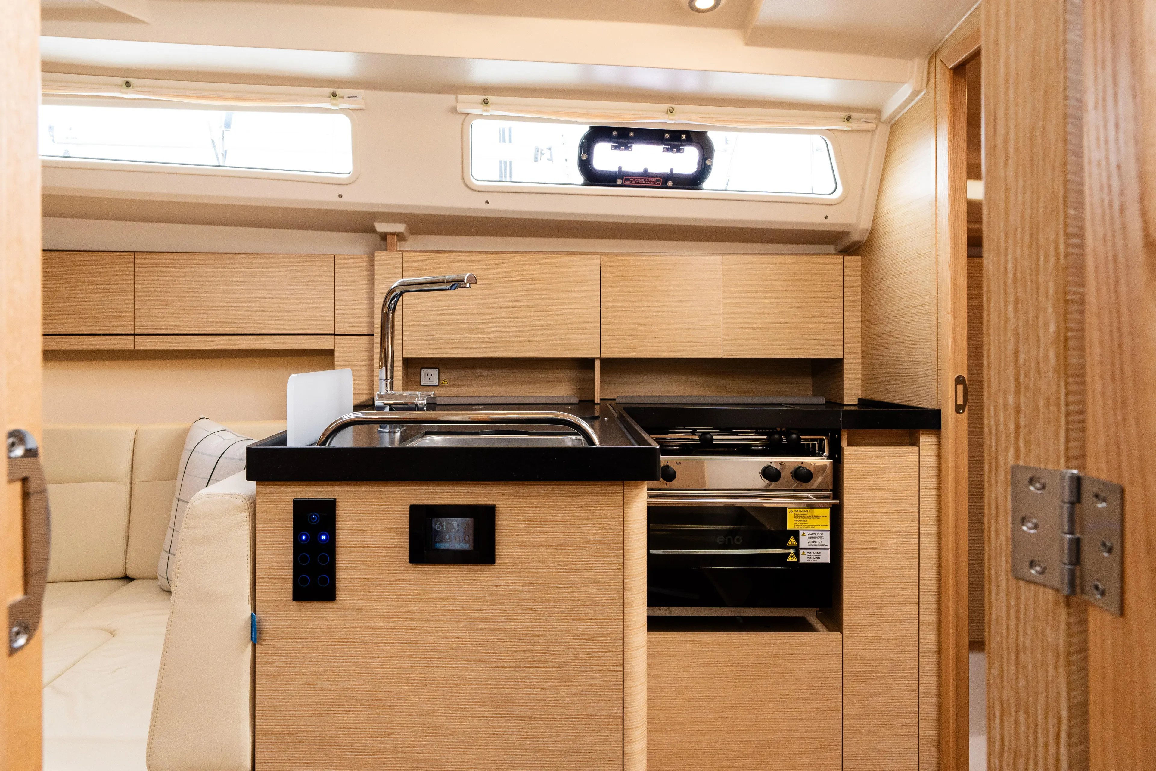 The Siren's Song Yacht Photos Pics 2023 Hanse 348 yacht interior with modern kitchen, wooden cabinetry, and sleek design.