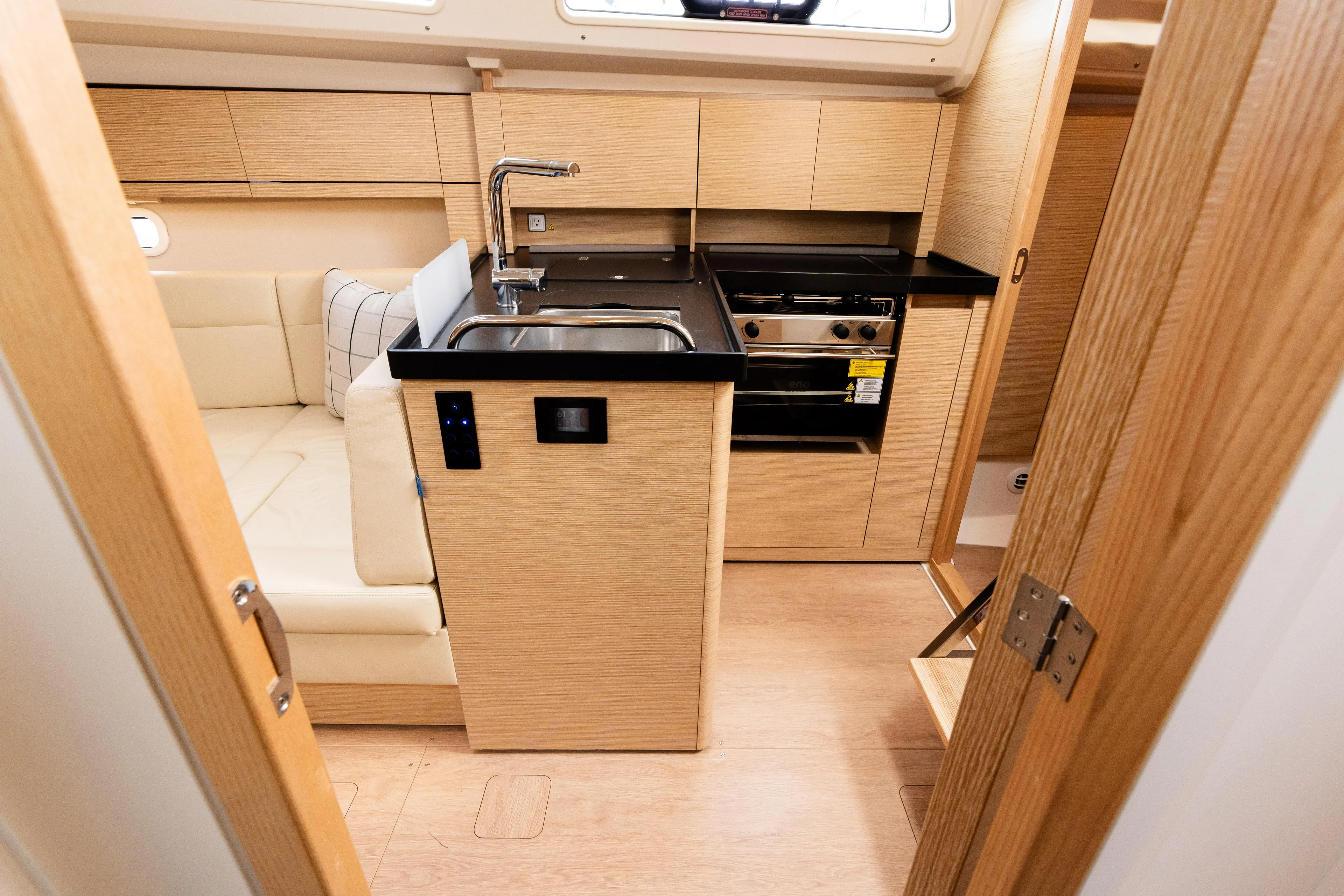 The Siren's Song Yacht Photos Pics 2023 Hanse 348 yacht interior with modern kitchen and seating area.