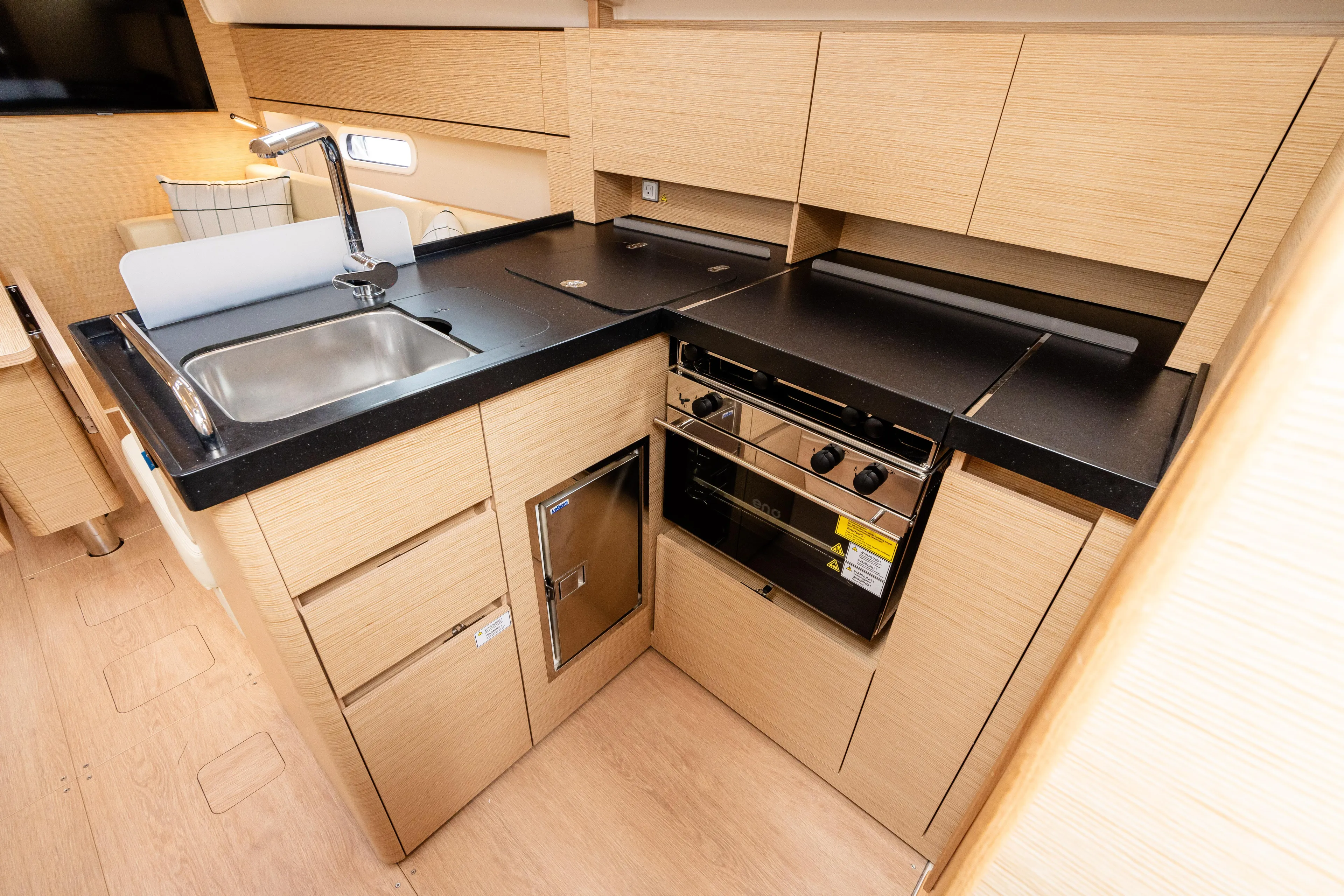 The Siren's Song Yacht Photos Pics Modern kitchen in 2023 Hanse 348 yacht with sleek cabinetry and appliances.