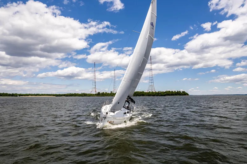 The Siren's Song Yacht Photos Pics Sailing yacht Hanse 348, 2023 model, navigating open waters under a clear blue sky.