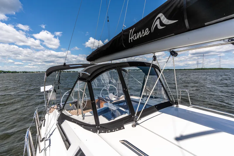The Siren's Song Yacht Photos Pics 2023 Hanse 348 sailboat on open water under a clear blue sky.