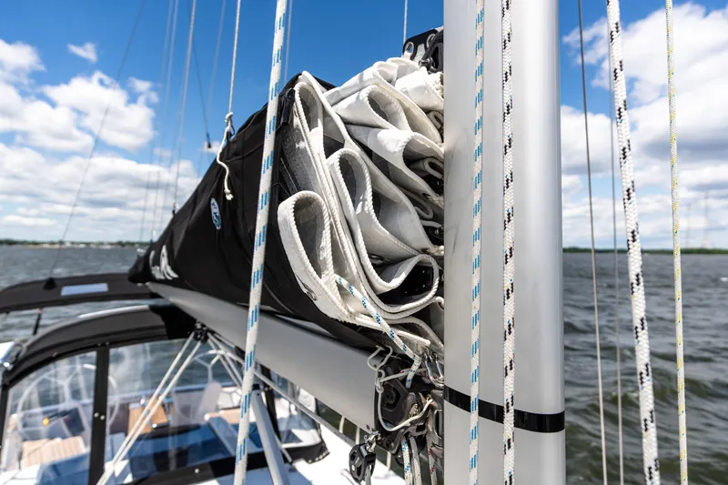 The Siren's Song Yacht Photos Pics 2023 Hanse 348 sailboat mast and rigging against a cloudy sky on the water.