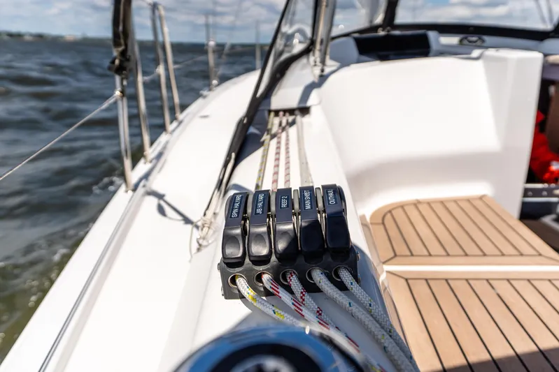 The Siren's Song Yacht Photos Pics 2023 Hanse 348 sailboat deck with control lines and ocean view.