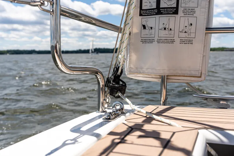 The Siren's Song Yacht Photos Pics Sailing on a 2023 Hanse 348 yacht, featuring deck details and safety instructions.