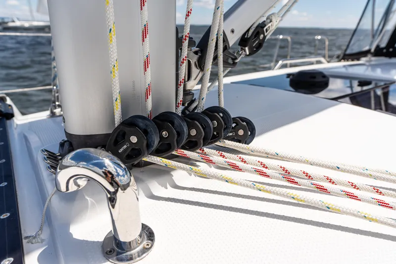 The Siren's Song Yacht Photos Pics 2023 Hanse 348 sailboat deck with rigging and pulleys, sailing on open water.