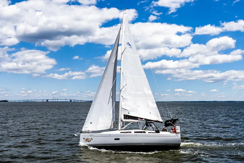 The Siren's Song Yacht Photos Pics 2023 Hanse 348 sailboat navigating under clear skies on open water.