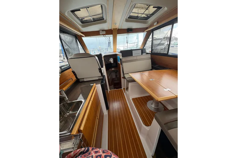 Andiamo Yacht Photos Pics Interior of 2020 Cutwater C-28 boat with wood accents and seating area.