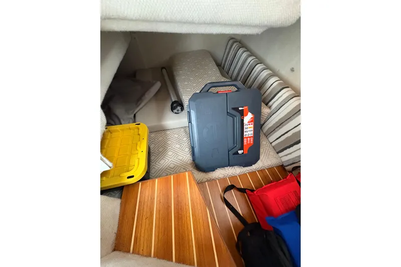 Andiamo Yacht Photos Pics Interior of a 2020 Cutwater C-28 boat with storage items and striped cushions.