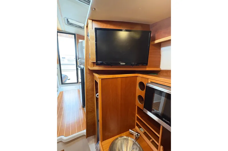 Andiamo Yacht Photos Pics Interior of 2020 Cutwater C-28 boat with TV, microwave, and sink.