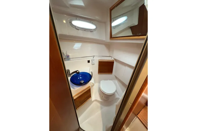 Andiamo Yacht Photos Pics Compact bathroom in 2020 Cutwater C-28 boat with blue sink and modern fixtures.