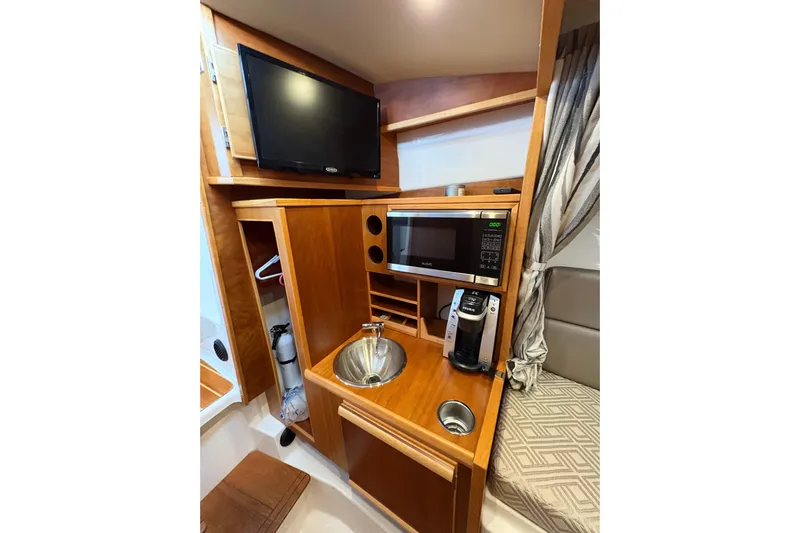 Andiamo Yacht Photos Pics 2020 Cutwater C-28 interior with TV, microwave, sink, and coffee maker.