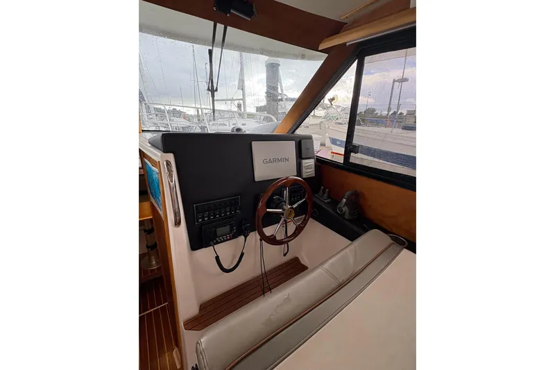 Andiamo Yacht Photos Pics 2020 Cutwater C-28 boat interior with Garmin navigation system and wooden steering wheel.