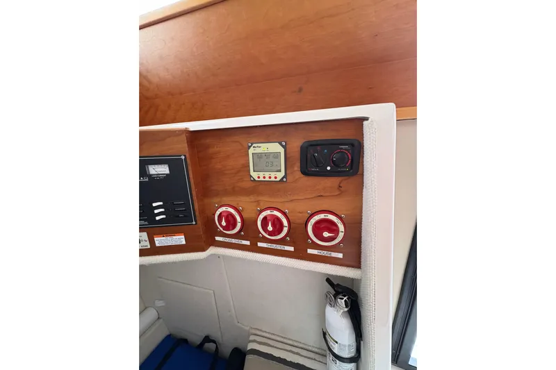 Andiamo Yacht Photos Pics Control panel of a 2020 Cutwater C-28 boat with switches and fire extinguisher.
