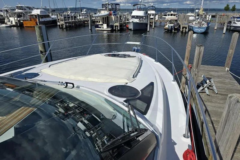  Yacht Photos Pics 2009 Four Winns V435 yacht docked at a marina, showcasing sleek design and spacious deck.