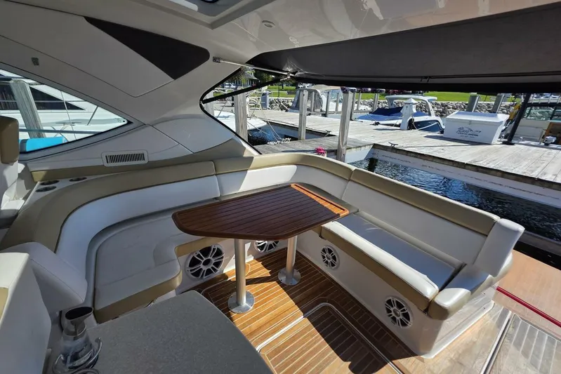  Yacht Photos Pics Interior of 2009 Four Winns V435 yacht with seating and wooden table by the dock.