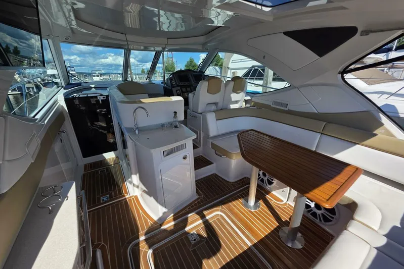 Yacht Photos Pics 2009 Four Winns V435 yacht interior with sleek seating, wooden table, and modern amenities.