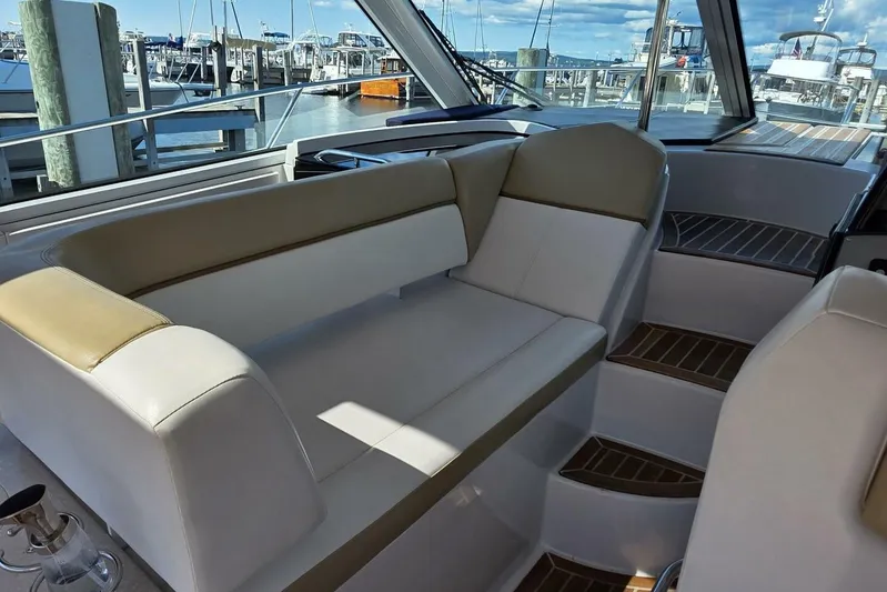  Yacht Photos Pics Interior of 2009 Four Winns V435 yacht with beige seating and marina view.