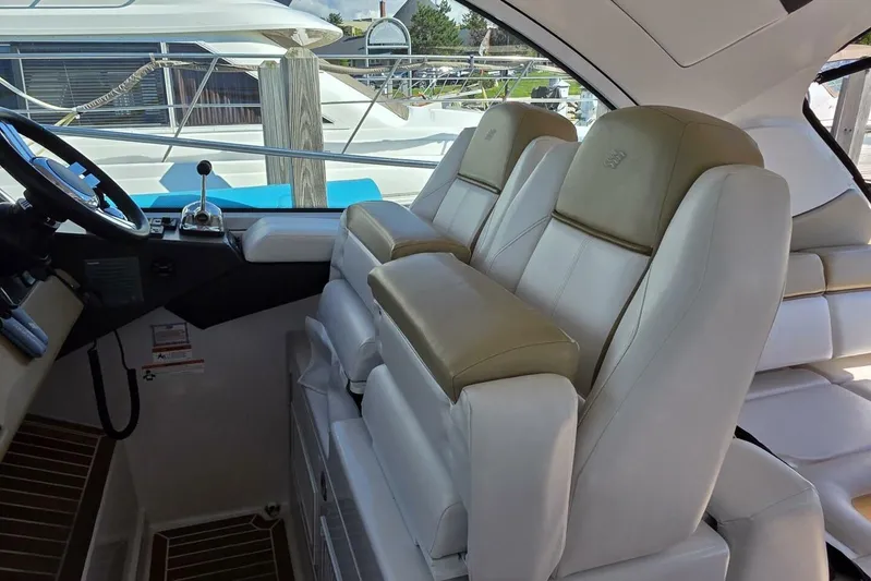  Yacht Photos Pics 2009 Four Winns V435 yacht interior with beige leather seats and steering wheel.