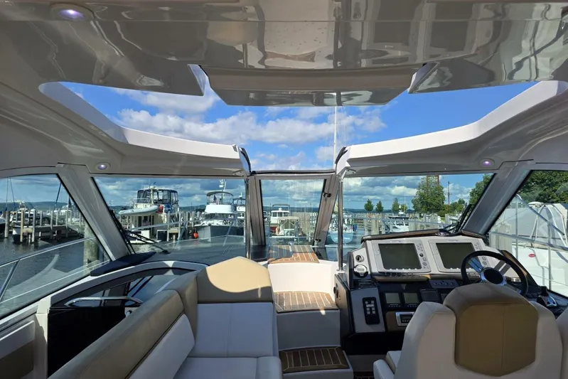  Yacht Photos Pics Interior view of 2009 Four Winns V435 yacht cockpit with marina background.