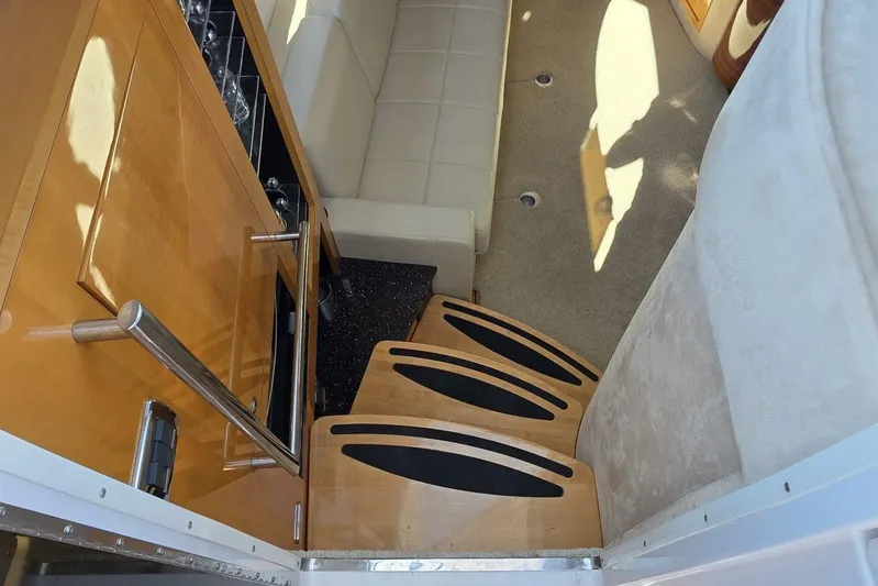  Yacht Photos Pics Interior of 2009 Four Winns V435 yacht with wooden stairs and beige seating.