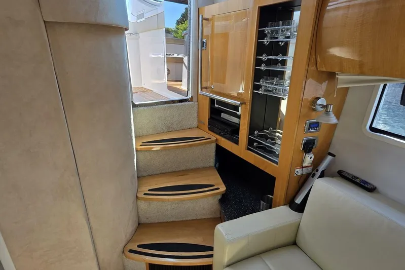  Yacht Photos Pics Interior of 2009 Four Winns V435 yacht with wooden cabinetry and carpeted stairs.