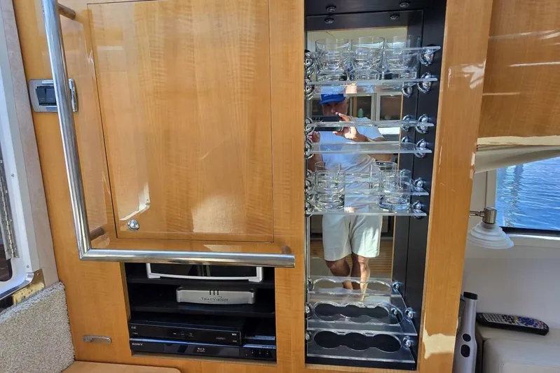  Yacht Photos Pics Interior of 2009 Four Winns V435 yacht with glassware cabinet and entertainment system.