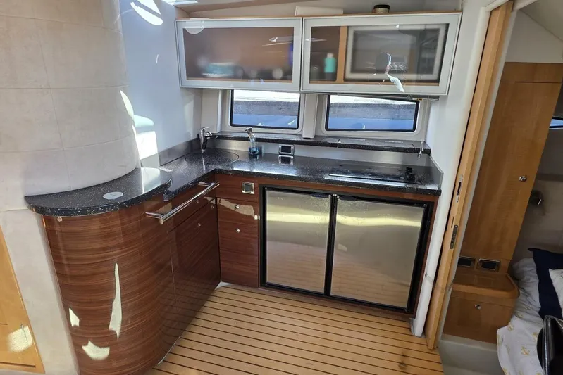  Yacht Photos Pics Luxurious 2009 Four Winns V435 yacht kitchen with sleek countertops and modern appliances.