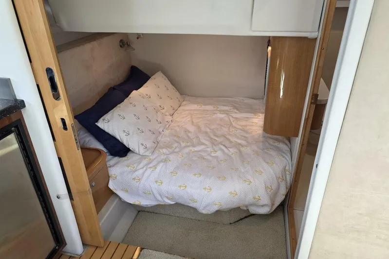  Yacht Photos Pics Cozy cabin bedroom in 2009 Four Winns V435 yacht with anchor-themed bedding.