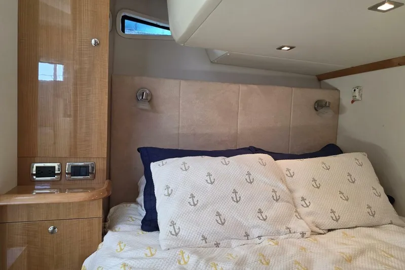  Yacht Photos Pics Luxurious 2009 Four Winns V435 yacht cabin with cozy bedding and elegant wood finish.