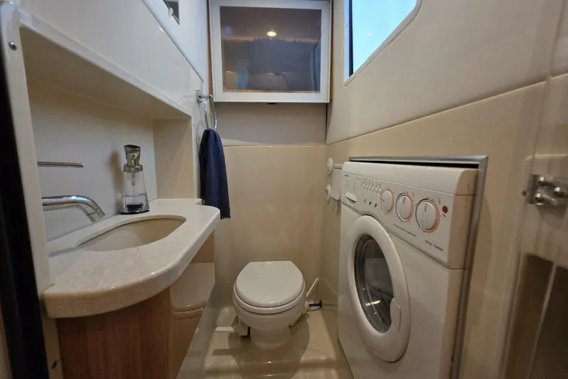  Yacht Photos Pics Bathroom with washer in 2009 Four Winns V435 yacht, featuring sink and toilet.