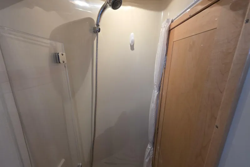  Yacht Photos Pics Shower area in 2009 Four Winns V435 boat with wooden door and handheld showerhead.