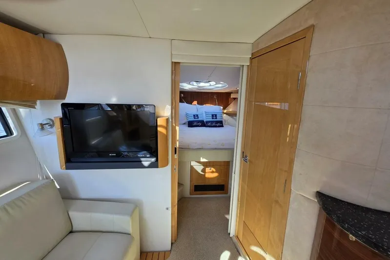  Yacht Photos Pics Interior of 2009 Four Winns V435 yacht with TV, sofa, and bedroom view.