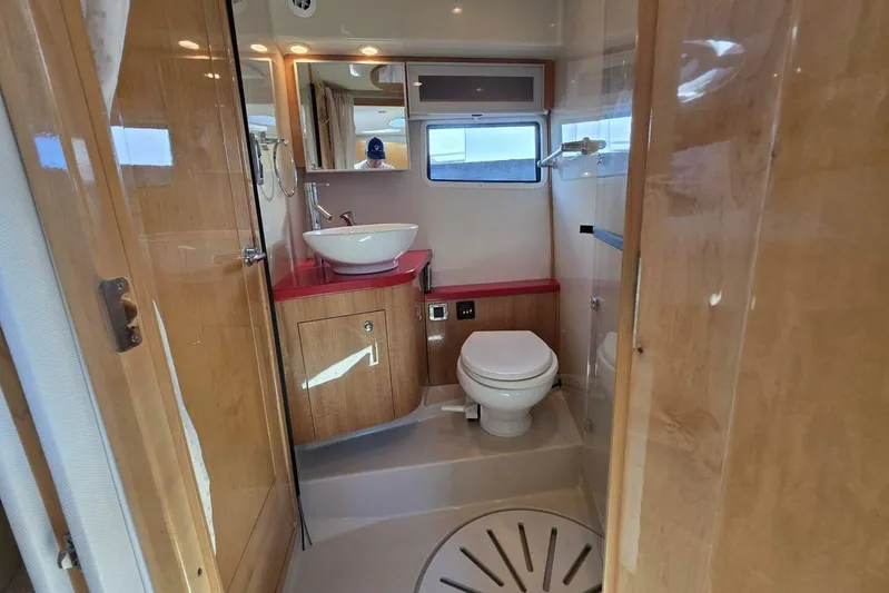  Yacht Photos Pics Luxurious 2009 Four Winns V435 yacht bathroom with modern fixtures and wooden cabinetry.