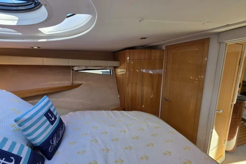  Yacht Photos Pics Interior of 2009 Four Winns V435 yacht cabin with bed and wooden cabinetry.