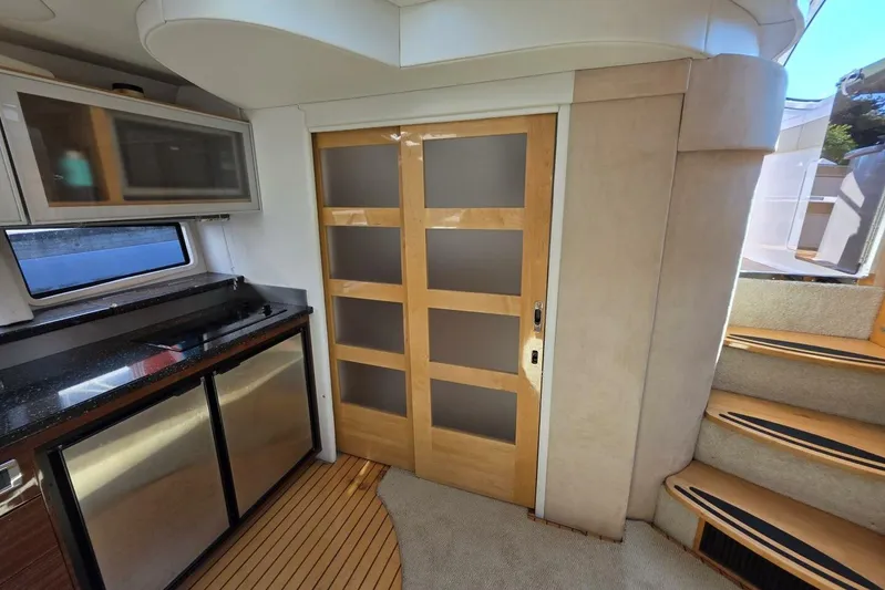  Yacht Photos Pics Interior of 2009 Four Winns V435 yacht with modern kitchen and wooden sliding door.